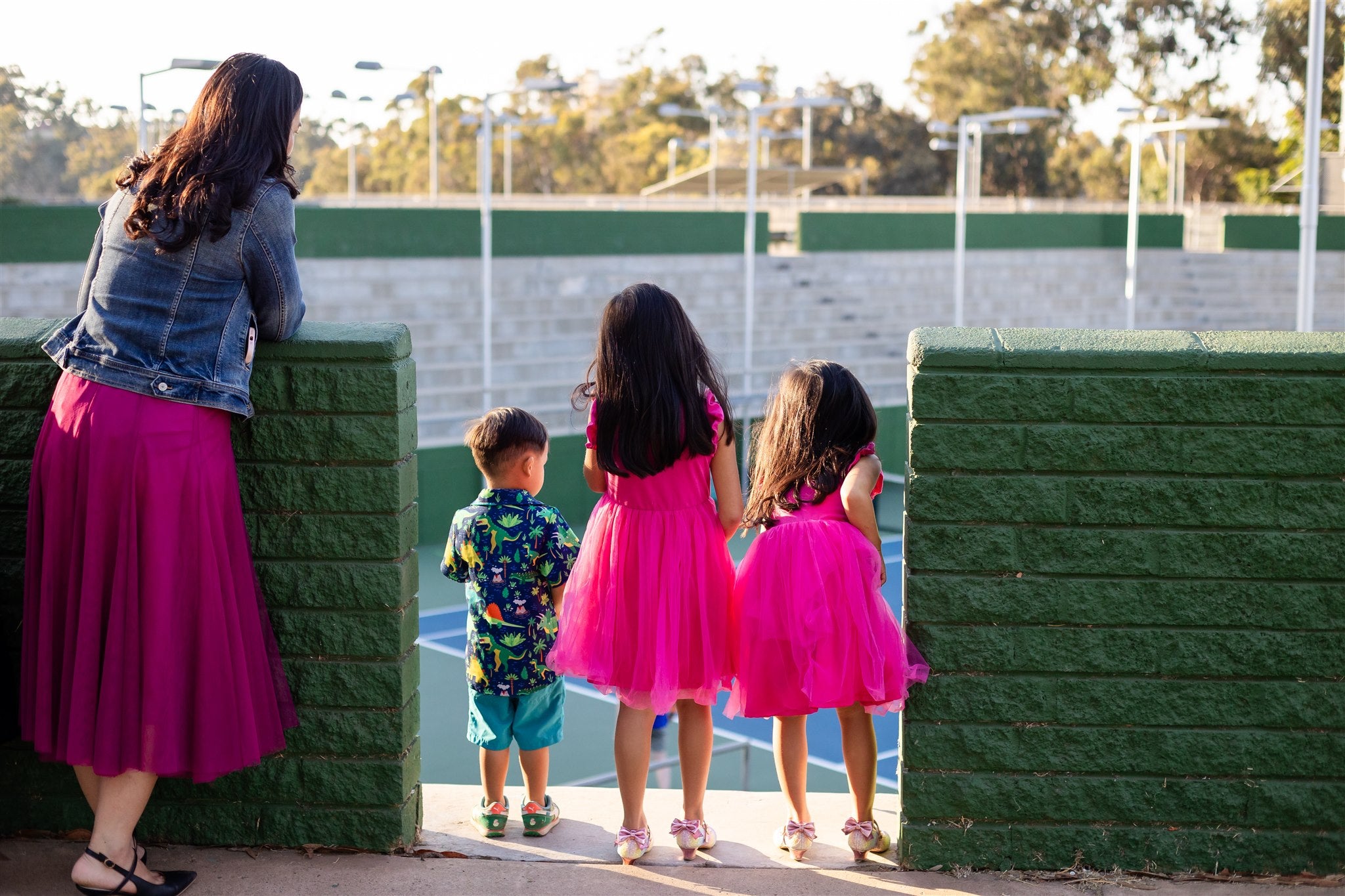 Dr. Michelle Hu walking outside with her children.